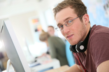 Aufkleber - Student with eyeglasses sitting in front of desktop