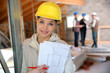 © goodluz - Young woman in construction professional training