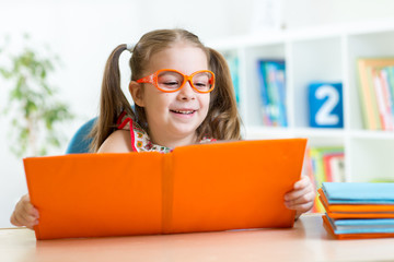 Wall Mural - kid at the table with books