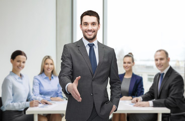 Wall Mural - businessman with open hand ready for handshake