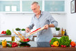 canvas print picture - Mature man in the kitchen prepare salad IX