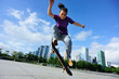 skateboarder practice skateboarding trick ollie at city