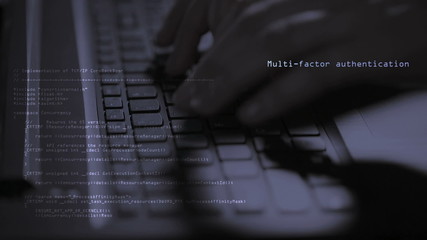 computer hacker typing on a laptop