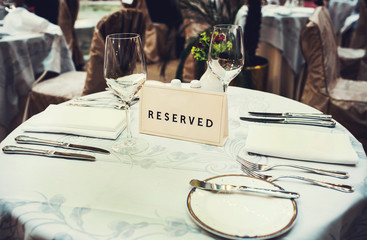 Reserved sign on a table in restaurant