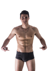 Wall Mural - Young man in underwear pointing fingers at empty blank space for