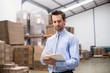 © WavebreakmediaMicro - Manager holding clipboard in warehouse