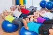 © WavebreakMediaMicro - People stretching on exercise balls in fitness club