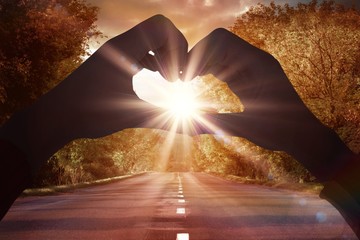 Poster - Composite image of woman making heart shape with hands