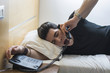 © theartofphoto - Sleepy Man on Bed Yawning While Talking at the Telephone