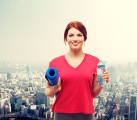 Wall Mural - smiling girl with bottle of water after exercising