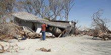 Man Grieving Over Destroyed House