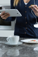 Wall Mural - Using tablet during eating sandwich