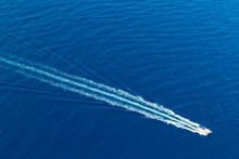 Boat Surf Foam Aerial From Prop Wash In Blue Sea
