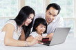 © Creativa Images - Family doing purchasing online at home