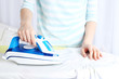 © Africa Studio - Woman ironing shirt on ironing board in room
