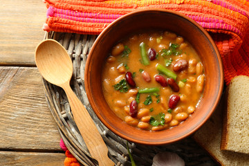Wall Mural - bean soup in bowl on wooden table background