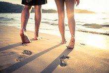 Lovers Walking On The Beach