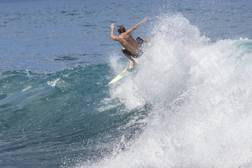 Wall Mural - Extreme surfer riding giant ocean wave in Hawaii