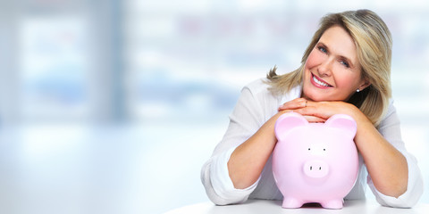 Senior woman with piggy bank.