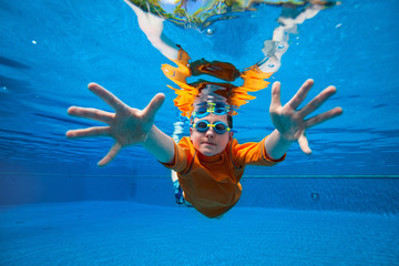 Wall Mural - Boy swimming underwater