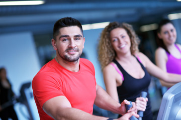 Wall Mural - Group of people running on treadmills