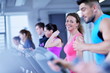 © .shock - Group of people running on treadmills