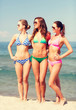 © Syda Productions - group of smiling young women on beach