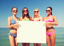 Group Of Smiling Women With Blank Board On Beach