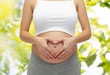 © Syda Productions - close up of pregnant woman touching her bare tummy