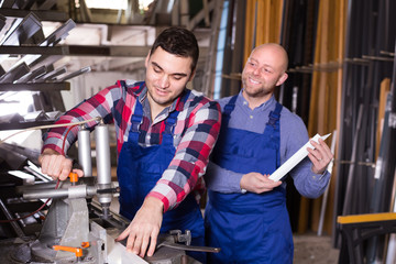 Two workmen in PVC shop