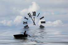 Silhouette Of A Boat Rowing Toward A Clock.