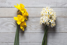 Yellow And White Narcissus Flowers On Wooden Background