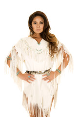 Native American woman in white hands on hips looking