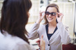 © Westend61 - Woman at the optician trying on sunglasses