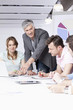© Westend61 - Germany, Bavaria, Munich, Men and woman discussing in office