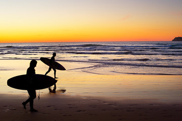 Surfers at sunset, Portugal