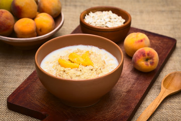 Wall Mural - Bowl of oatmeal porridge with peach slices