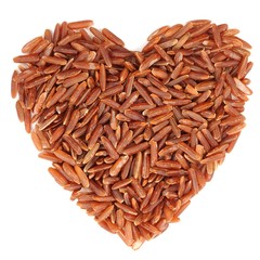 Red raw rice in heart shape, isolated