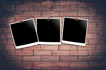 retro polaroid photo frames on brick wall in a background image