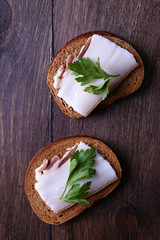 Wall Mural - Sandwiches with lard and parsley on wooden background