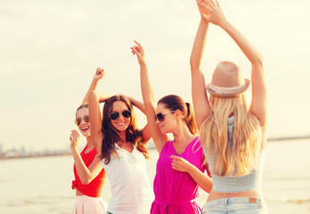 Sticker - group of smiling women dancing on beach