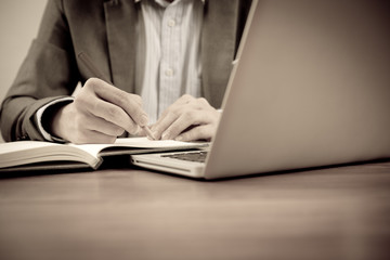 Hands of a man working with laptop