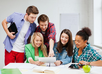 Wall Mural - students looking at tablet pc at school