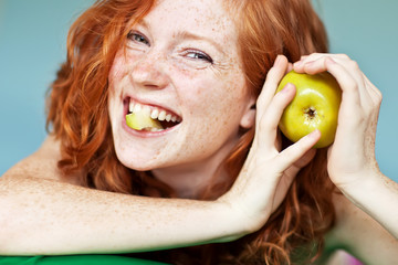 Portrait of young beautiful woman with apple 