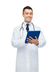 Wall Mural - smiling male doctor in white coat with tablet pc