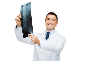 Wall Mural - smiling male doctor in white coat holding x-ray