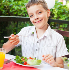 Sticker - Child eating salad at a cafe