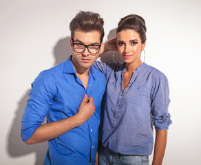 Poster - cute couple posing on grey studio background.