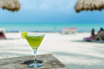 Fresh Margarita cocktail on a table at tropical exotic beach