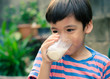 © wckiw - Littl boy drinking milk in the park vintage colo style